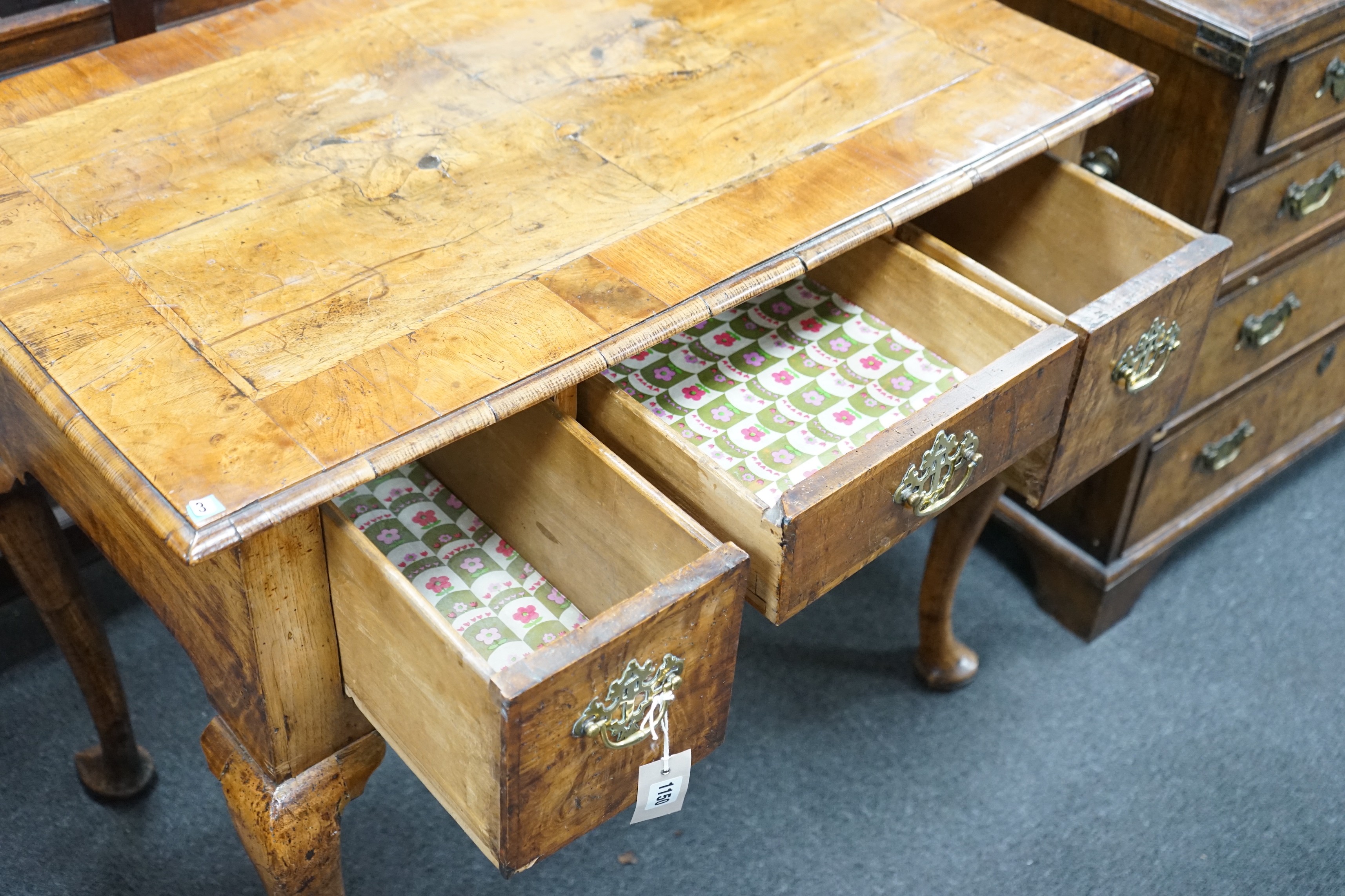 A George I walnut lowboy with quarter veneered top, width 87cm, depth 55cm, height 74cm